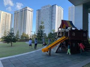 a group of children playing on a playground in a park at C&C Cool View Tagaytay Staycation in Tagaytay