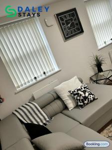 a living room with a couch and a window at Failsworth Luxury Apartment with Free Parking by Daley Stays in Manchester