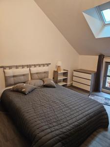 a bedroom with a large bed in a attic at Les Logis du rempart in Loches