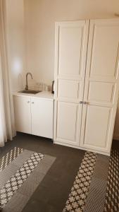 a kitchen with white cabinets and a sink at Tenuta il Bosco con parcheggio in Bitonto