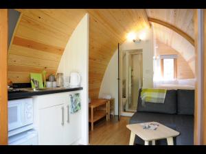 sala de estar con sofá y habitación con tabla de surf en South Kerry Glamping, en Cahersiveen