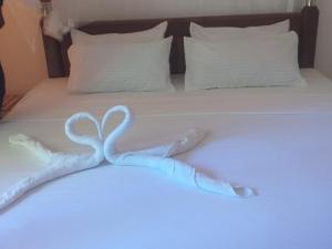 a swan made out of towels on a bed at Saimon Villa in Mirissa