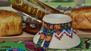 a knitted hat is sitting on a table with bread at Casa Vădeanu in Sighetu Marmaţiei +34 photos