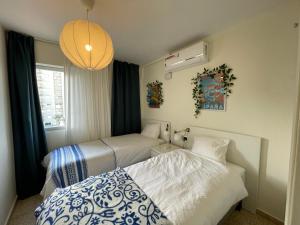 um quarto com 2 camas e um candeeiro em EPIS - large luxury apartment with sea view em Benicàssim