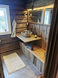 a bathroom with a sink in a wooden cabin at Stabburet på Balsnes Gård in Hitra