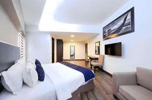 クアラルンプールにあるRPC Blissful Homes & Hotelのベッドとソファ付きのホテルルーム