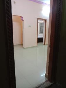 a hallway with a room with a white floor at SriArunachala Shiva home stay in Tiruvannāmalai
