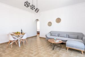 a living room with a couch and a table at Brizet Apartments Sea & Side Sea View in Pollonia