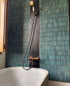 a bath tub in a bathroom with a shower at Baku living villa in Ngaglik