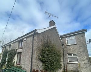 a brick house with a antenna on top of it at Tara Vista Apartment in Navan