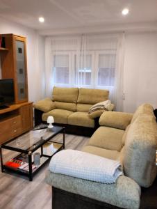 a living room with a couch and a coffee table at Casa Raquelina in Gijón