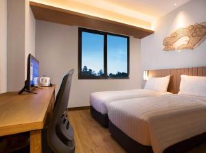 Кровать или кровати в номере BATIQA Hotel Cirebon