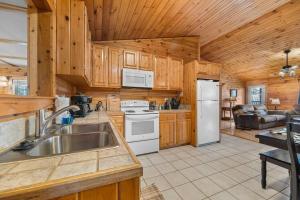 een keuken met een spoelbak en een koelkast bij King Beds, Views, EasyRoads, PoolTable, Spa, Theater, Outdoor fun in Sevierville +47 foto's