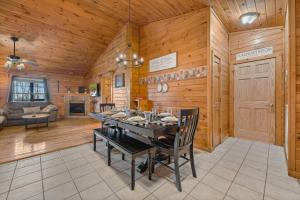 a dining room with a table and chairs in a cabin at King Beds, Views, EasyRoads, PoolTable, Spa, Theater, Outdoor fun in Sevierville