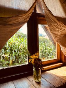 a vase with flowers sitting on a window sill at Villa 47 in Nuwara Eliya