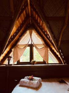 a bed in a tent with a window at Villa 47 in Nuwara Eliya