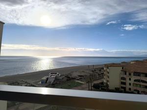 a view of the beach from the balcony of a condo at Appartement de vacances - Splendide vue sur mer, Parking privé in Le Barcarès