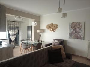 a living room with a couch and a table at Angela's Seaview Apartment in Lefkandi Chalkidas