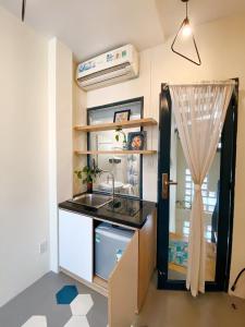 a kitchen with a sink and a counter top at Laca Hostel in Ho Chi Minh City