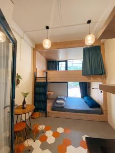 a room with a bunk bed and a table at Laca Hostel in Ho Chi Minh City