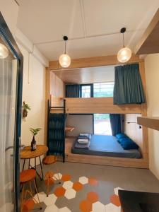 a small room with a bunk bed and a table at Laca Hostel in Ho Chi Minh City