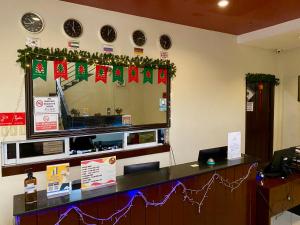 a reception desk with christmas decorations on the wall at Asiatel Airport Hotel in Manila