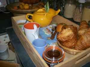a drawer with a tray of croissants and a tea pot at la coupe d'or in Braud-et-Saint-Louis