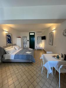 a hotel room with a bed and a table and a table and chairs at Matteo's House Taormina in Taormina