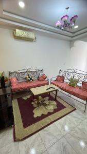 a living room with two couches and a table at Dar elrayen in Tozeur