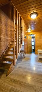 a staircase in a wooden cabin with a bench and a table at Akureyri Cottages in Akureyri