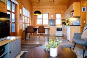 a kitchen and living room with a table and chairs at Akureyri Cottages in Akureyri
