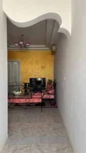 a living room with a couch and a television at Dar elrayen in Tozeur