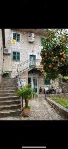 an orange tree in front of a building at Old stone house in historical area in Split
