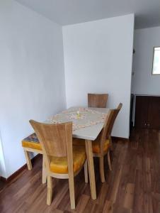 a dining room table with two chairs and a table and a table and chairsktop at Apartamento Amoblado in Bogotá