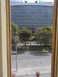 a view of a parking lot with a yellow car at Apartamento Amoblado in Bogotá