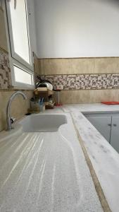 a kitchen with a sink and a bath tub at Dar elrayen in Tozeur