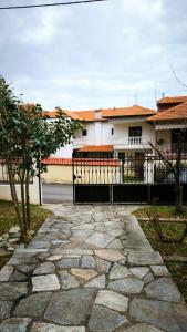 a stone walkway in front of a house at Litohome Litochoro The Gods Oasis in Litochoro