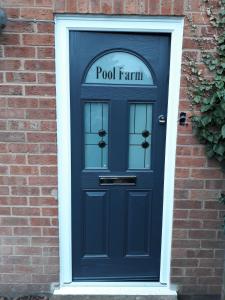 a blue door with the words pool farm on it at Pool Farm in Redditch