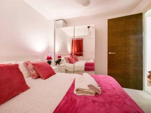 a bedroom with a large bed with pink sheets at Pass the Keys Cathedral Quarter City Centre Walk Everywhere in Belfast