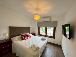 a bedroom with a large bed and a window at BuenaVid estancias in Cafayate