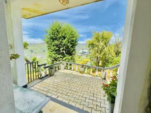 a walkway leading to a balcony with a view at House of Leisure in Nuwara Eliya