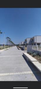 an empty parking lot in front of a building at Holiday Apartment in Draç