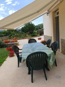 a table and chairs on a patio with a canopy at Vallée du Serein in Marcilly-Ogny