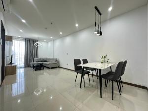 a dining room and living room with a table and chairs at Qhome in Ho Chi Minh City