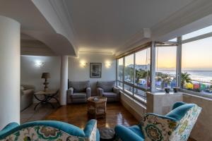 a living room with a view of the ocean at Beachfront Seaview in Cape Town