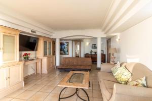a living room with a couch and a table at Beachfront Seaview in Cape Town