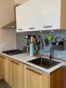 a kitchen with a sink and a stove at macalu 1 in Prato Nevoso