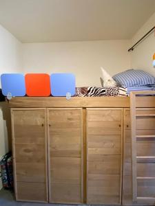 a bedroom with a bed on top of wooden cabinets at macalu 1 in Prato Nevoso