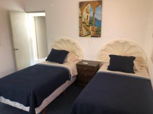 Ένα ή περισσότερα κρεβάτια σε δωμάτιο στο Casa Picón Cancún +35 φωτογραφίες
