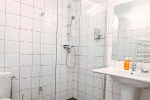 a bathroom with a shower and a sink at Lo d Ici, Gite de groupe et de Caractere in Nasbinals